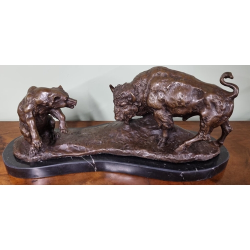 A Bronze figure buffalo and bear. Dimensions (H x W x D) approx. 20x49x16cm