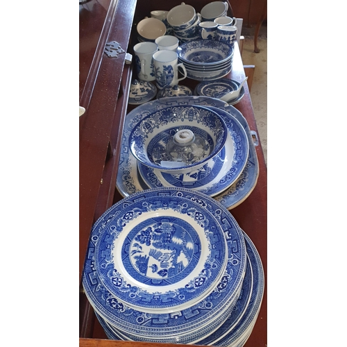 573 - A good quantity of Blue and White dinner Wares mostly Old Willow pattern.