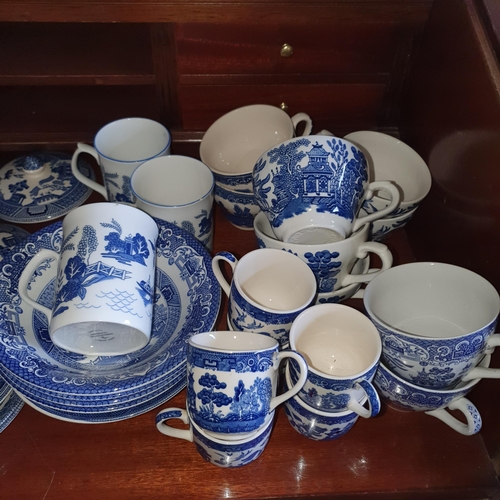 573 - A good quantity of Blue and White dinner Wares mostly Old Willow pattern.