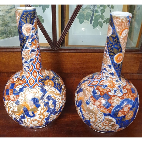 677 - A pair of 19th Century Oriental ewer shaped Bud Vases, one having damage to the stem along with a la... 