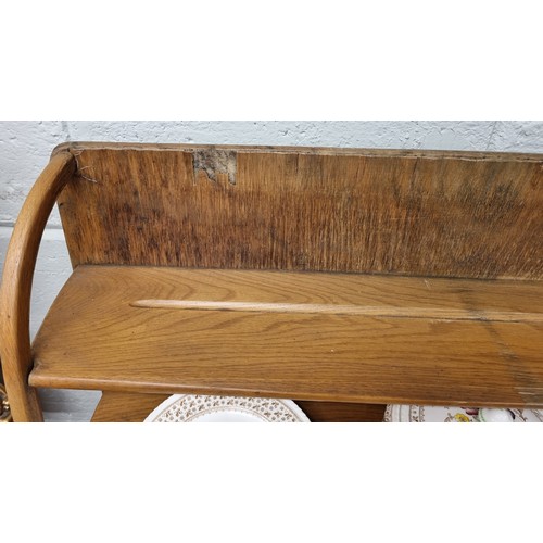 98a - An Ercol style elm sideboard, with a two tier plate rack, on a base with three drawers and three cup... 