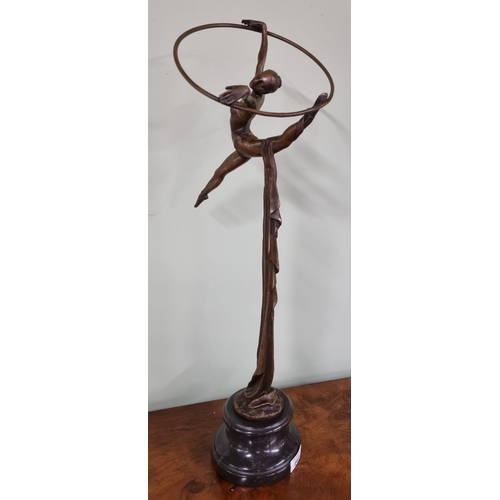 260 - A fabulous Bronze figure of a gymnast with ring and cloth. Dimensions (H x W x D) approx. 58 x 23 x ... 