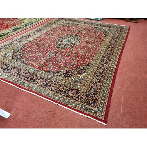 253 - A rich Red ground Persian Kashan Carpet with traditional Kashan medallion design. 380 x 292cm approx... 