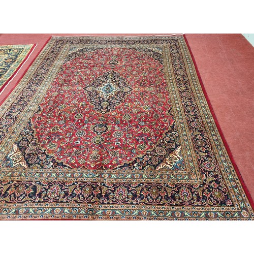 253 - A rich Red ground Persian Kashan Carpet with traditional Kashan medallion design. 380 x 292cm approx... 