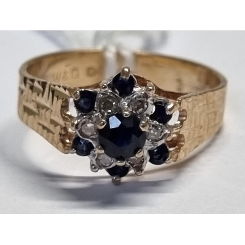 348 - A 9ct Gold, Diamond and Sapphire Ring. N1/2.