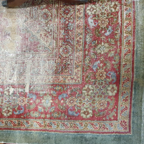 470 - An extremely large Carpet with green and red ground and allover decoration. (quite badly worn). 400 ... 