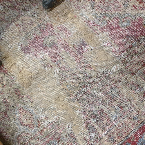 470 - An extremely large Carpet with green and red ground and allover decoration. (quite badly worn). 400 ... 