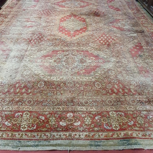 470 - An extremely large Carpet with green and red ground and allover decoration. (quite badly worn). 400 ... 