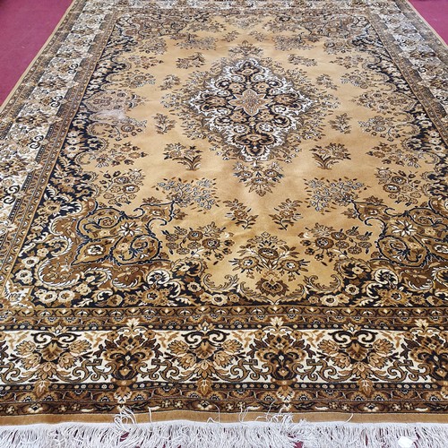 29 - A Large Tan/Brown Rug. L 380 x 273 cm approx.