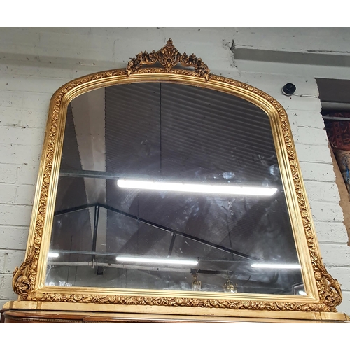 21 - A Fantastic Timber Gilt arch top Overmantel Mirror with highly carved outline and cartouche carved t... 