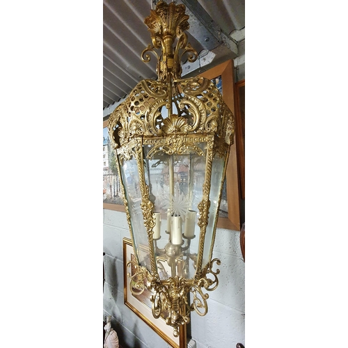 126 - A Superb Brass Hall Lantern with highly carved outline and etched glass panels. Drop 85 cm approx.