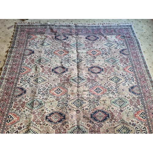 67 - A Large Middle Eastern Carpet with geometric design in neutral tones of brown, green and red, 320 x ... 