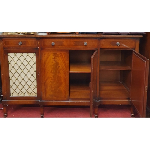 76 - A good Mahogany and Veneered breakfront low Cabinet having three frieze drawers a central cupboard f... 