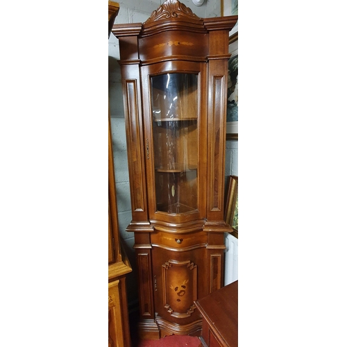 161 - A Mahogany and Veneered Corner Cabinet with serpentine outline. W67 x H209cm approx.