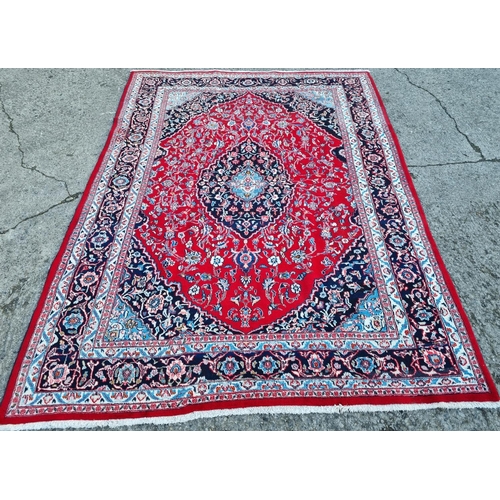 254 - A really good quality Red ground Persian Kashan Carpet with a traditional Kashan design with blue bo... 