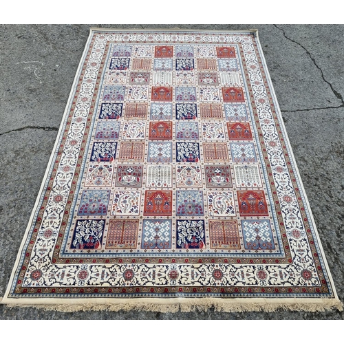 345 - An Ivory ground full pile Carpet with a traditional Persian panel design, 310 x 198 cm approx.