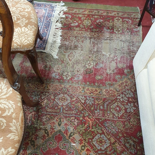 337 - An extremely large Carpet with green and red ground and allover decoration. (quite badly worn). 400 ... 