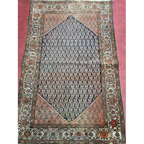 65 - A Persian Rug with unique medallion design on cream ground. 205 x 123cm approx.