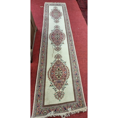 78 - A Cream ground Runner with unique medallion design. 430 x 90cm approx.