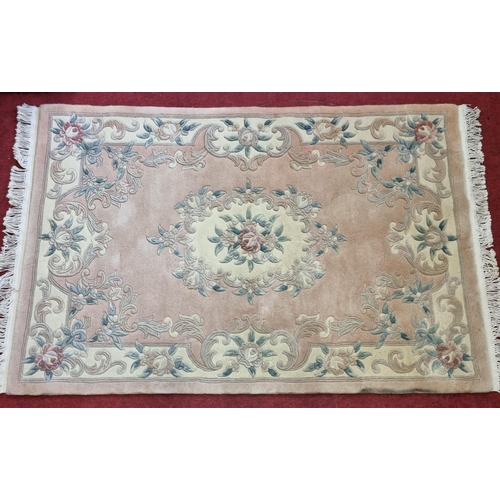 202 - A pink ground Chinese Rug with floral decoration.
L 200 x W 122 cm approx.