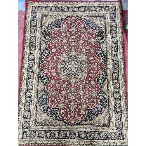 277 - A Burgundy ground Rug with multi borders.
L 170 x 120 cm approx.