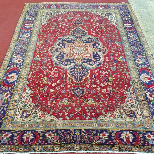 253 - A superb quality Red ground Tabriz Carpet with a central medallion design surrounded by a rich Blue ... 
