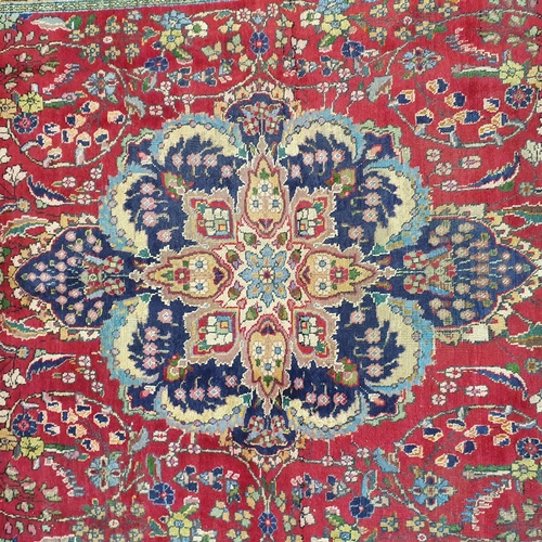 253 - A superb quality Red ground Tabriz Carpet with a central medallion design surrounded by a rich Blue ... 