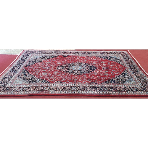 254 - A really good quality Red ground Persian Kashan Carpet with a traditional Kashan design with blue bo... 