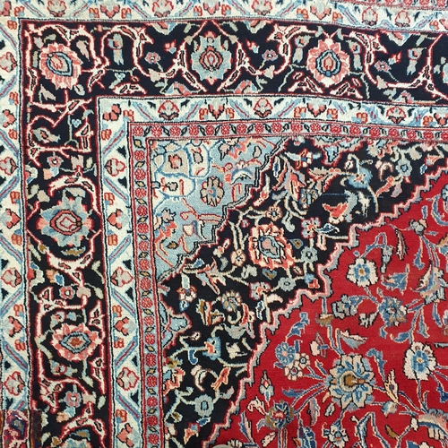 254 - A really good quality Red ground Persian Kashan Carpet with a traditional Kashan design with blue bo... 