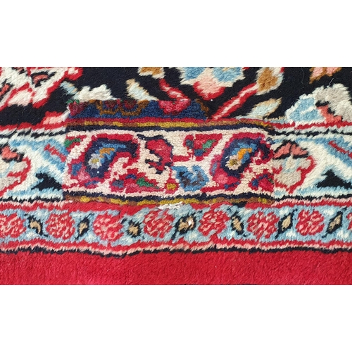 254 - A really good quality Red ground Persian Kashan Carpet with a traditional Kashan design with blue bo... 