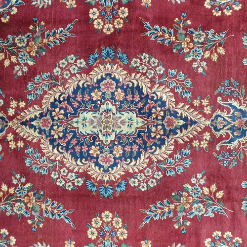 83 - A fantastic rich Red/ Burgundy ground Iranian Carpet with a bespoke floral medallion design from the... 