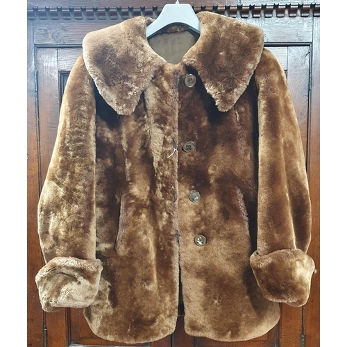 382 - A Faux Fur Coat , light brown silk Lined .