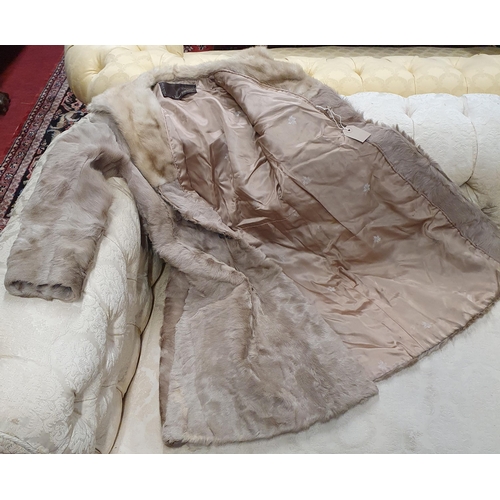 383 - A Good Fur Coat, light brown silk lined by Jack Bloom of Dublin. Small size.