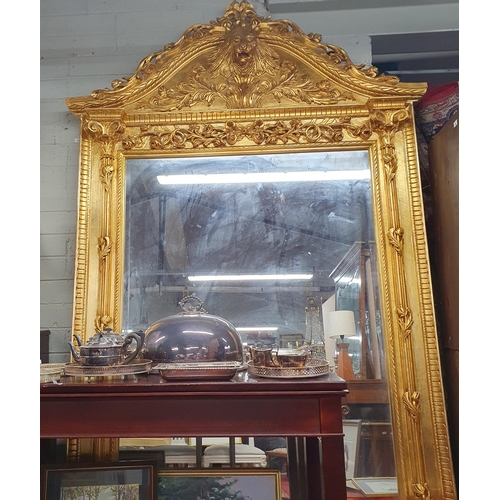 34 - An extremely large Plaster and Gilt Overmantel Mirror with lions head top bevelled edge glass and hi... 