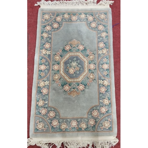 860 - A good Oriental Green ground Rug with floral decoration.