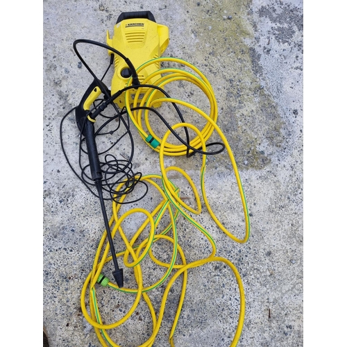 826C - A Karcher power Washer and hose.