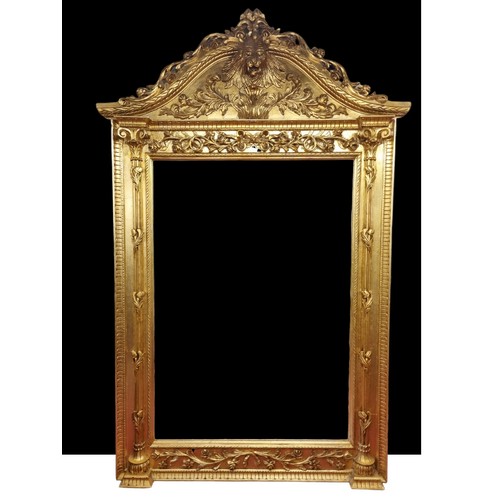 An extremely large Plaster and Gilt Overmantel Mirror with lions head top bevelled edge glass and highly moulded outline. 270 x 170 cm approx.