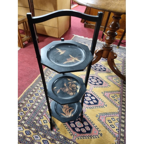 96 - A late 19th Century ebonised cake Stand with painted outline along with an Oriental bulbous Vase. W ... 