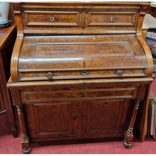 132 - A 19th Century Continental Walnut cylinder Bureau, the top with two drawers, a roll top to reveal a ... 