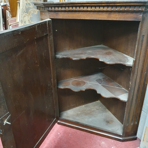 205 - A 19th Century possibly earlier Oak hanging corner display Cabinet with single raised and fielded pa... 