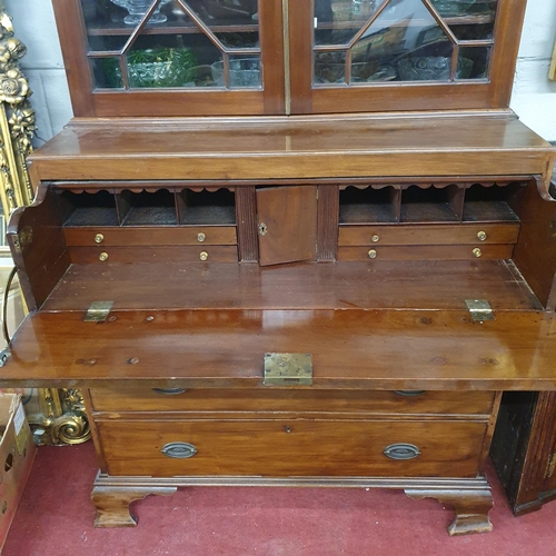 244 - An early 19th Century Mahogany Secretaire Bookcase with a highly carved architectural pierced pedime... 