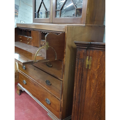 244 - An early 19th Century Mahogany Secretaire Bookcase with a highly carved architectural pierced pedime... 