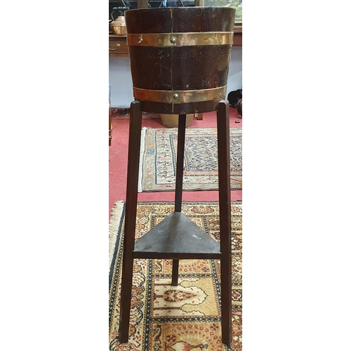 25 - A 19th Century Oak and Brass bound Planter on stand by R A Lister & Co. Makers label inside. D 26 x ... 
