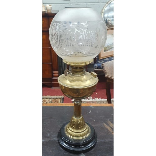 308 - A 19th Century Brass Oil Lamp with shade. H 52 cm approx.