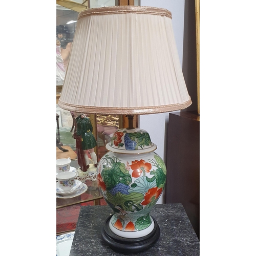 476 - A 20th Century hand painted Oriental Table Lamp with floral decoration. H 42 cm approx.