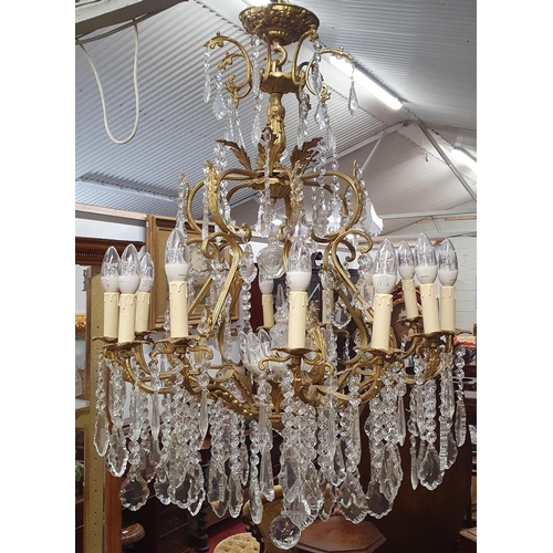 493 - A Magnificent eight branch Brass and Crystal Chandelier profusely decorated with drop crystals. En s... 