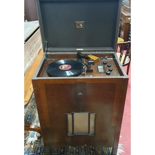 509 - A vintage Wooden cased His Masters Voice radiogram with a lift lid enclosing playing deck, to includ... 