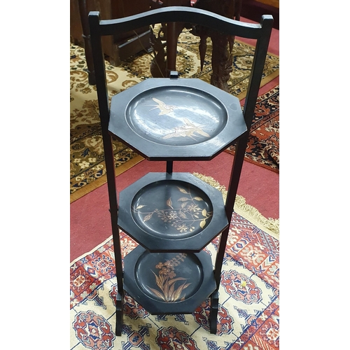 96 - A late 19th Century ebonised cake Stand with painted outline along with an Oriental bulbous Vase. W ... 