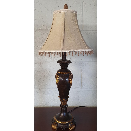 551 - A good Ebonised and Gold coloured Table Lamp with shade. H 48 cm approx.