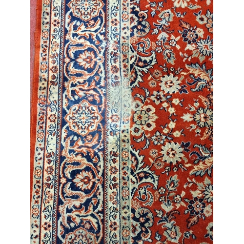 1124 - A large Red ground Carpet with multi borders and medallion design, 290 x 200 cm.